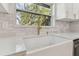 White farmhouse sink with gold faucet in a modern kitchen setting at 3815 N 14Th St, Tampa, FL 33603