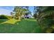Large grassy backyard with tropical landscaping at 4514 Dewey Dr, New Port Richey, FL 34652