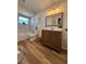 Clean bathroom with a tub, vanity, and wood-look floors at 4514 Dewey Dr, New Port Richey, FL 34652