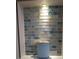 Bathroom detail featuring a unique glass tile backsplash at 4514 Dewey Dr, New Port Richey, FL 34652