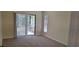 Bright bedroom with neutral carpeting and sliding glass doors to patio at 4514 Dewey Dr, New Port Richey, FL 34652