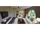 Bright and airy living room with large window and vaulted ceiling at 4514 Dewey Dr, New Port Richey, FL 34652