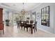 Bright dining room featuring a wood table, six chairs, and a view of the pool at 4531 Swordfish Dr, Bradenton, FL 34208