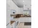 Modern kitchen with white cabinets, granite countertops, and stainless steel appliances at 4531 Swordfish Dr, Bradenton, FL 34208