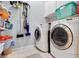 Laundry room with washer, dryer, and ample storage shelving at 4531 Swordfish Dr, Bradenton, FL 34208