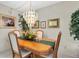 Bright dining room with wood table, chandelier, and seating for four at 5090 Bay Ne St # 117, St Petersburg, FL 33703