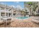 Community pool with patio furniture and pergola at 5221 Bayshore Blvd # 37, Tampa, FL 33611