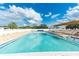 Inviting community swimming pool with plenty of lounge chairs at 5306 Vera St, Zephyrhills, FL 33542