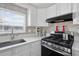 Kitchen with stainless steel appliances and stone backsplash at 5306 Vera St, Zephyrhills, FL 33542