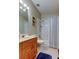 Clean bathroom with a tub shower and wood vanity at 531 Canal Way, Oldsmar, FL 34677