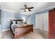 Bright bedroom featuring light blue walls and a walk-in closet at 555 Gulf Dr, Crystal Beach, FL 34681