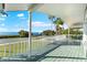 Large deck with water views and palm trees at 555 Gulf Dr, Crystal Beach, FL 34681