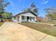 Cute bungalow with a large front yard and a long concrete driveway at 5918 N Eustace Ave, Tampa, FL 33604