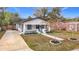 Newly renovated bungalow with a concrete driveway and a well-maintained lawn at 5918 N Eustace Ave, Tampa, FL 33604