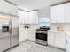 Bright kitchen featuring stainless steel appliances and white cabinetry at 5918 N Eustace Ave, Tampa, FL 33604