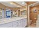 Bathroom with double vanity, large mirror, and shower at 6450 Shoreline Dr # 9502, St Petersburg, FL 33708
