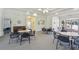 Community room with tables, chairs, and a piano at 6450 Shoreline Dr # 9502, St Petersburg, FL 33708