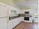 Efficient kitchen with white cabinets and modern appliances at 6450 Shoreline Dr # 9502, St Petersburg, FL 33708
