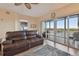 Spacious living room with hardwood floors, balcony access, and leather sofa at 6450 Shoreline Dr # 9502, St Petersburg, FL 33708