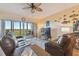 Living room with leather furniture, balcony access, and hardwood floors at 6450 Shoreline Dr # 9502, St Petersburg, FL 33708