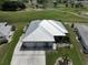 Single-story home with metal roof, three-car garage, and golf course view at 676 Allegheny Dr, Sun City Center, FL 33573