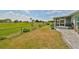 Landscaped backyard with patio and golf course view at 676 Allegheny Dr, Sun City Center, FL 33573