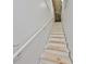 Unfinished basement stairs with white railing at 676 Allegheny Dr, Sun City Center, FL 33573