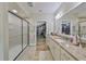 Bathroom featuring granite countertops, double sinks, and a walk-in closet at 676 Allegheny Dr, Sun City Center, FL 33573