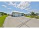 Two-car garage with white doors and a large driveway at 676 Allegheny Dr, Sun City Center, FL 33573