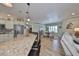 Open kitchen with island, granite counters & view of dining area at 676 Allegheny Dr, Sun City Center, FL 33573