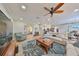 Spacious living room with hardwood floors, comfortable seating, and large TV at 676 Allegheny Dr, Sun City Center, FL 33573