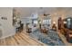 Spacious living room with hardwood floors, comfortable seating, and large TV at 676 Allegheny Dr, Sun City Center, FL 33573