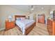 Large bedroom with a king-size bed, wooden furniture, and hardwood floors at 676 Allegheny Dr, Sun City Center, FL 33573