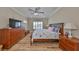 Comfortable main bedroom with king bed, dresser, and plenty of natural light at 676 Allegheny Dr, Sun City Center, FL 33573