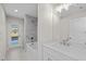 Clean bathroom with tub, single vanity, and exterior access at 7258 Bridgeport Ln, Englewood, FL 34224