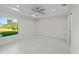 Bright bedroom with large window and ceiling fan at 7258 Bridgeport Ln, Englewood, FL 34224
