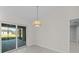 Bright dining room features sliding glass doors leading to a patio at 7258 Bridgeport Ln, Englewood, FL 34224