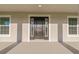 Dark brown front door with sidelights and a covered porch at 7258 Bridgeport Ln, Englewood, FL 34224