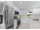 New kitchen with white shaker cabinets and stainless steel appliances at 7258 Bridgeport Ln, Englewood, FL 34224