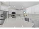 White kitchen with stainless steel appliances and a large island at 7258 Bridgeport Ln, Englewood, FL 34224