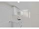 Bright laundry room with white cabinets and quartz countertops at 7258 Bridgeport Ln, Englewood, FL 34224