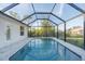 Inviting screened pool with ample patio space at 7258 Bridgeport Ln, Englewood, FL 34224