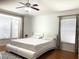 Bright bedroom with a king-size bed, window seating, and wood floors at 8408 Canterbury Lake Blvd, Tampa, FL 33619