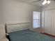 Bedroom with a queen bed and window with blinds at 8408 Canterbury Lake Blvd, Tampa, FL 33619