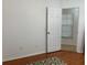 Simple bedroom with wood floors and door to another room at 8408 Canterbury Lake Blvd, Tampa, FL 33619