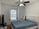 Bedroom with a queen bed and window with blinds at 8408 Canterbury Lake Blvd, Tampa, FL 33619