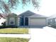 One-story house with a two-car garage and a well-maintained lawn at 8408 Canterbury Lake Blvd, Tampa, FL 33619