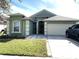 One-story home with green exterior and two-car garage at 8408 Canterbury Lake Blvd, Tampa, FL 33619