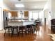 Open kitchen with granite island, hardwood floors, and stainless steel appliances at 8408 Canterbury Lake Blvd, Tampa, FL 33619