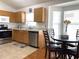 Eat-in kitchen with wood cabinets, stainless steel appliances, and a corner window at 8408 Canterbury Lake Blvd, Tampa, FL 33619